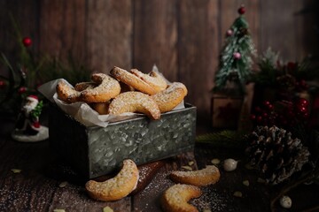 Holiday Almond crescent shortbread cookies on festive background, selective focus