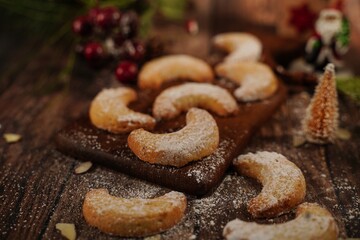 Holiday Almond crescent shortbread cookies on festive background, selective focus