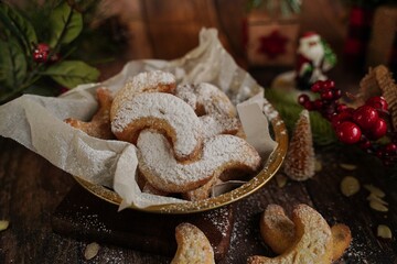 Holiday Almond crescent shortbread cookies on festive background, selective focus