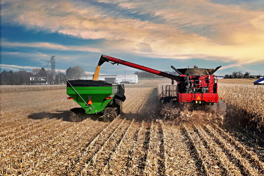 grain cart being loaded with corn from a combine harvester in  northern Illinois