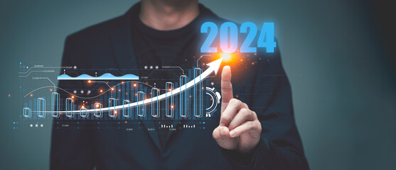 2024 Step into the world of finance and economics with a businessman's virtual screen analysis of investment trends in 2024. Explore the stock market's potential for growth and profit - obrazy, fototapety, plakaty