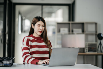 Young Happy Businesswoman Using Computer in Modern Office. Stylish Beautiful Manager Smiling, Working on Financial and Marketing Projects.