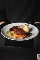 Fried chicken leg cooked with pear. Food concept on fire