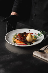 Fried chicken leg cooked with pear. Food concept on fire