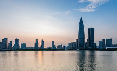 Fototapeta na wymiar Office building reflected in the water at sunset