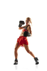 Bottom view of muscular young woman, boxing athlete in motion, training, punching isolated over white background. Concept of sport, active and healthy lifestyle, strength and endurance, body care