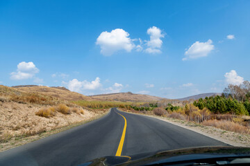 Country road through the hill in the autumn