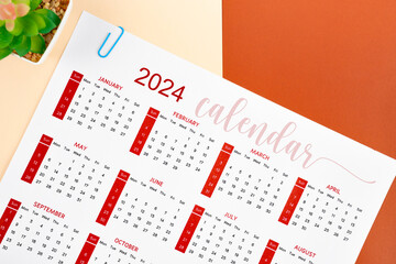 The 12 months desk calendar 2024 and paper clips.