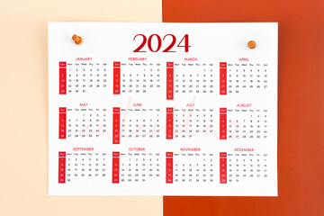12 months calendar page for 2024 year and wooden pins.