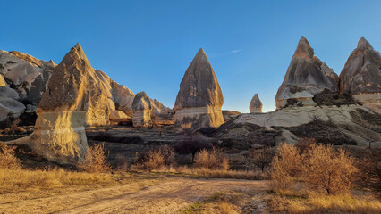 A diverse array of fairy chimneys punctuate the iconic Cappadocian landscape, each one telling a...