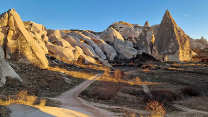 Mesmerizing formations of fairy chimneys rise in the Red Valley of Cappadocia, a surreal landscape...