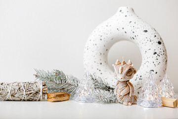 Candles concept. Christmas little dragon. Minimalism. Interior Design. Winter decoration. Scandinavian  ornament. Space for text. Christmas winter still life.