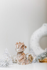 Candles concept. Christmas little dragon. Minimalism. Interior Design. Winter decoration. Scandinavian  ornament. Space for text. Christmas winter still life.
