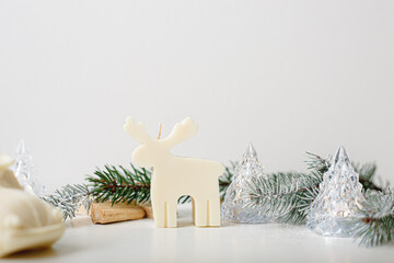 Miracle light candle deer with Christmas trees. White background, copy space. Winter Fairy tale...