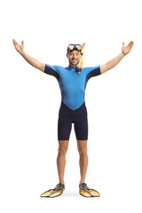 Full length portrait of a man wearing a diving suit, mask and fins spreading arms and smiling
