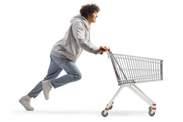Young man running with a shopping cart