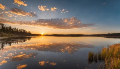 Foto op Canvas A sunset over a lake with a cloudy sky © vivekFx