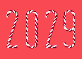 2029  made from sweet caramel canes, candies on red background