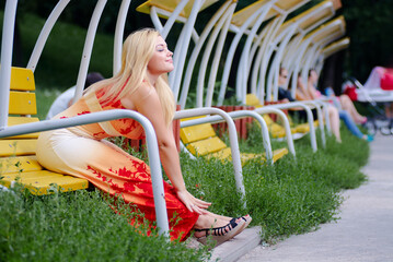 Portrait of beautiful young womn with long blonde hair outdoors.