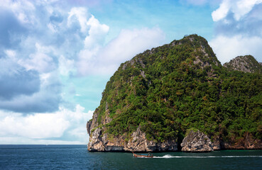 Cliff and the clear sea with long-tail near Phi Phi island in south of Thailand