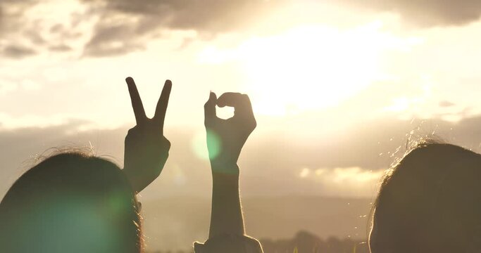 hands raised up against beautiful sunrise, number 2024.,Hands with New Year 2024 symbols,	
