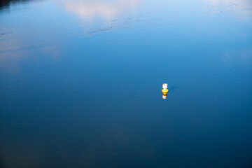 Fototapeta na wymiar Buoy on a Sea, Blue Water and Clouds Reflection, Edersee