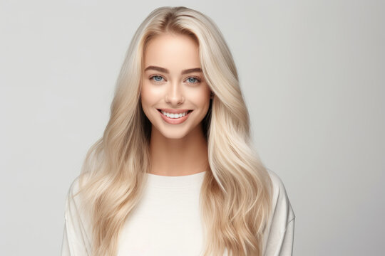 Portrait of beautiful smiling blonde young woman with clean fresh skin, isolated on white background
