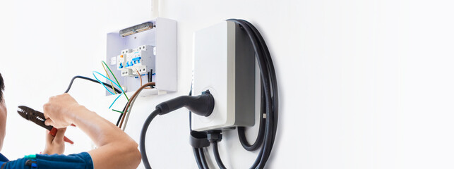Certified male Electrician Installing Home EV Charger