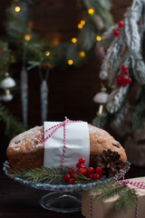 A Christmas cupcake on the background of a Christmas tree with lights. Serving flour products