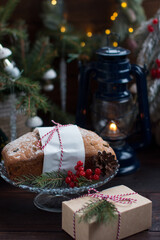 A Christmas cupcake on the background of a Christmas tree with lights. Serving flour products
