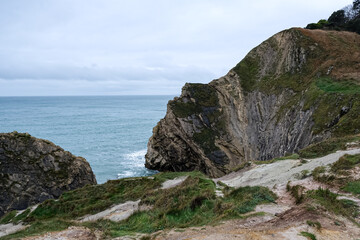 Lulworth Cove cliffs view on a way to Durdle Door. The Jurassic Coast is World Heritage Site on the English Channel coast of southern England. Dorset, UK. Jurassic coast view in Dorset, UK. Stair Hole