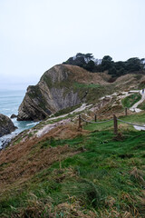 Lulworth Cove cliffs view on a way to Durdle Door. The Jurassic Coast is World Heritage Site on the English Channel coast of southern England. Dorset, UK. Jurassic coast view in Dorset, UK. Stair Hole