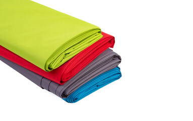 Four multi-colored rolls of fabric on a white background
