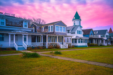 Oak Bluffs sunset skyline with well-preserved landmark houses and dramatic pink winter cloudscape over Ocean Park on the island of Martha's Vineyard in Dukes County, Massachusetts, United States