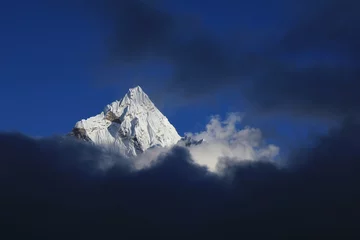 Papier Peint photo autocollant Ama Dablam Peak of Mount Ama Dablam reaching out of clouds, Nepal.