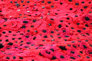 A Blanket of Knitted Red Remembrance Poppies.