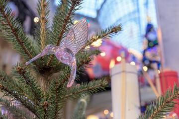 Glass christmas toy hummingbird on Christmas tree.