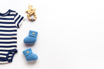 Flat lay of blue baby clothing and accessories. Kids bodysuit and shoes flat lay