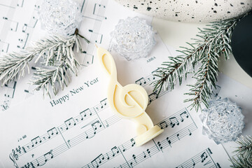 Miracle light treble clef candle with Christmas trees. White background, copy space. Winter Fairy...