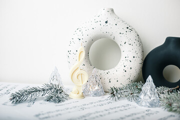 Miracle light treble clef candle with Christmas trees. White background, copy space. Winter Fairy...