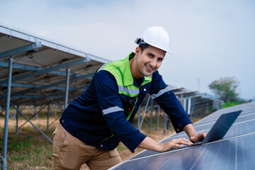 Engineers use laptops to monitor the performance of solar panels to confirm that the system is working. Professional engineer ideas for photovoltaic power plants