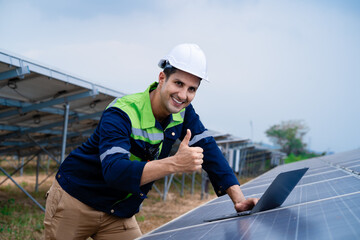 Engineers use laptops to monitor the performance of solar panels to confirm that the system is working. Professional engineer ideas for photovoltaic power plants