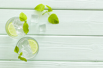 Refreshing cold cocktail with mint in glasses, top view