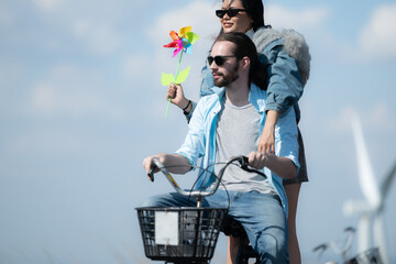 Back view of a young woman riding a bicycle with her boyfriend on the road