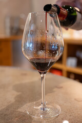 Tasting of red dry Saint-Emilion wine aged in French oak wooden barrels in cellar, Saint-Emilion...