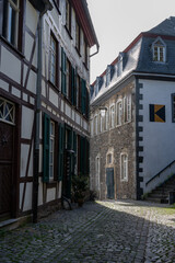 View of houses and streets of old colourful German town Monschau in bend of the river and hidden between the hills, Eifel national park, Germany