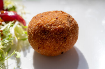 Tasty italian street food, deep fried aranchini rice balls with different filling
