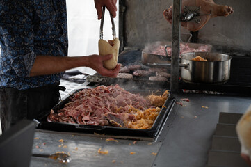 Street food in Belgium, grilled burgers, pork meat, white cabbage, making burgers with buns or pitas