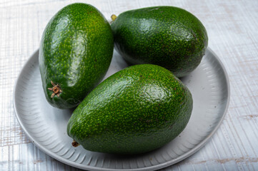 Green ripe avocado fruits from organic avocado plantation - healthy food