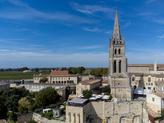 Aerial views of green vineyards, old houses and streets of medieval town St. Emilion, production of red Bordeaux wine on cru class vineyards in Saint-Emilion wine making region, France, Bordeaux